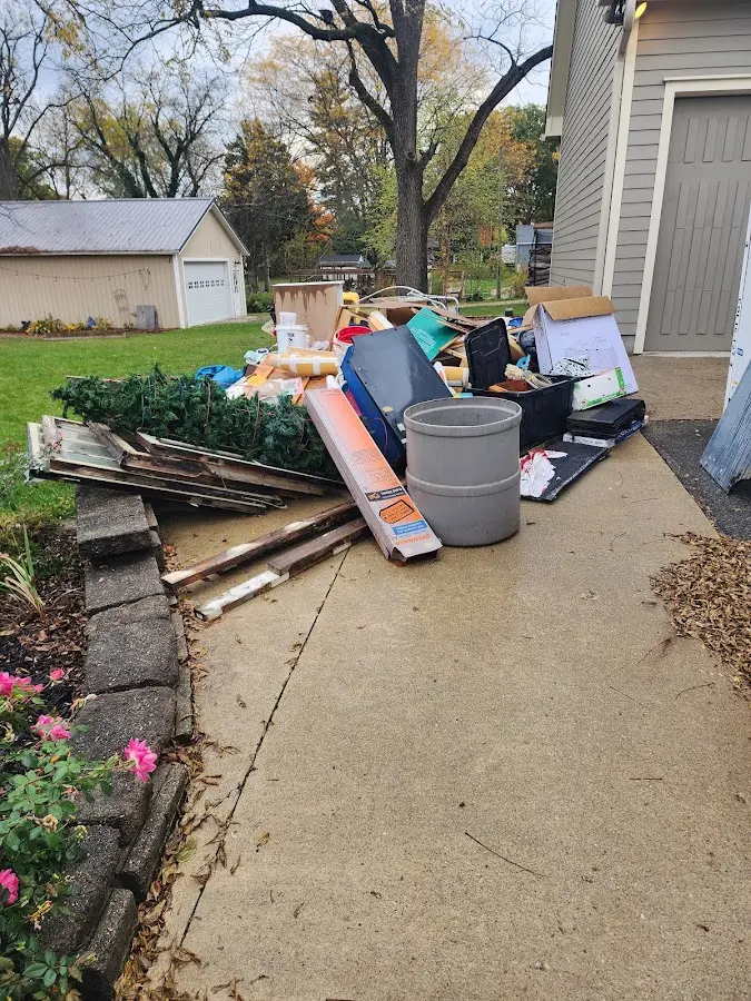 Dumpster being loaded with debris for 10 Yard Dumpster Rental in Nibley